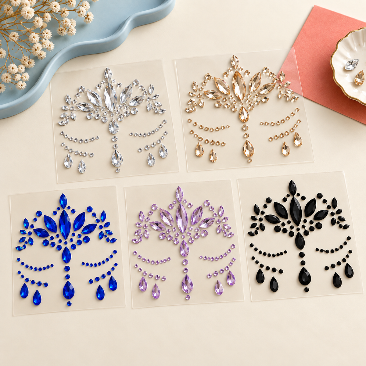 Five self-adhesive face and body gem sticker sheets — angled view